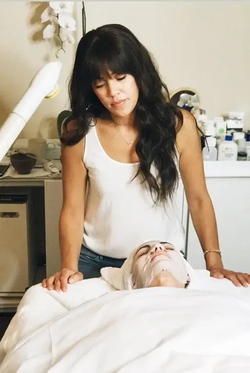 Shani Darden giving a client a facial treatment